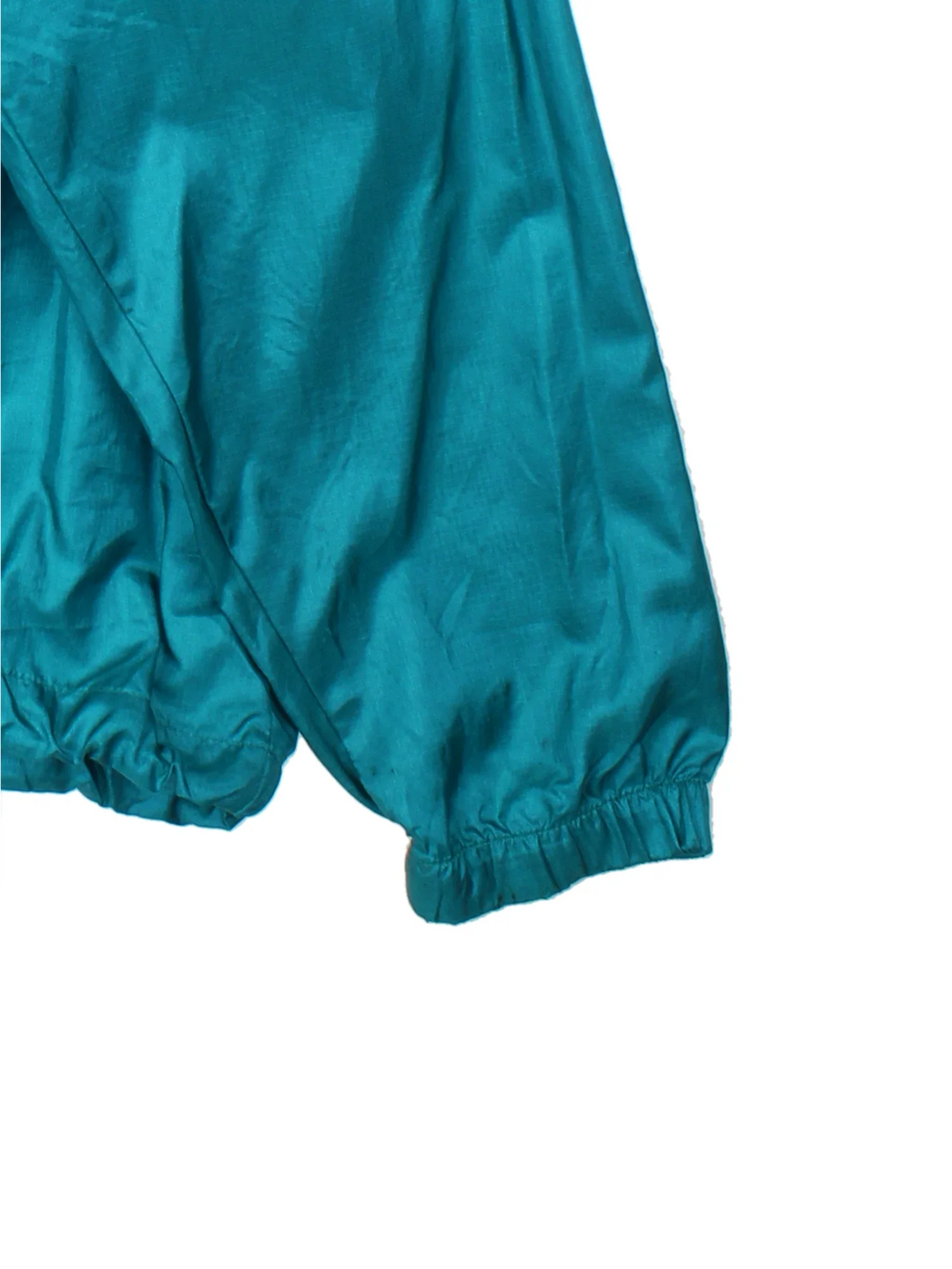 Vintage 90's Columbia Windbreaker Jacket in a green/purple colourway. 1/4 zip fastening, hooded and has large front pocket. Drawstring hem and has the logo embroidered on the front.