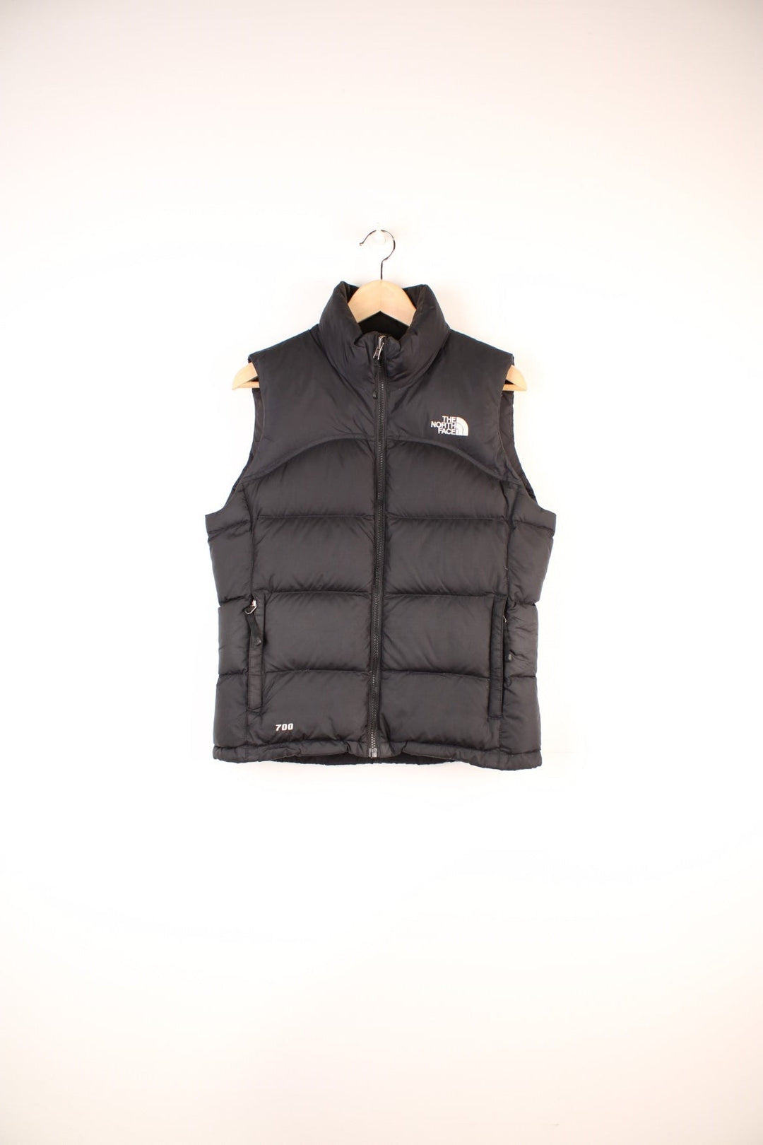 The North Face Gilet in a black colourway, zip up with side pockets, insulated, and has the logo embroidered on the front and back.