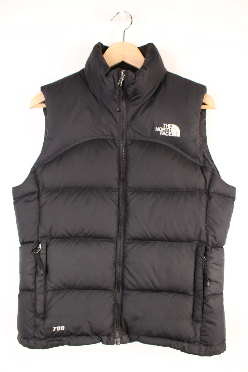 The North Face Gilet in a black colourway, zip up with side pockets, insulated, and has the logo embroidered on the front and back.