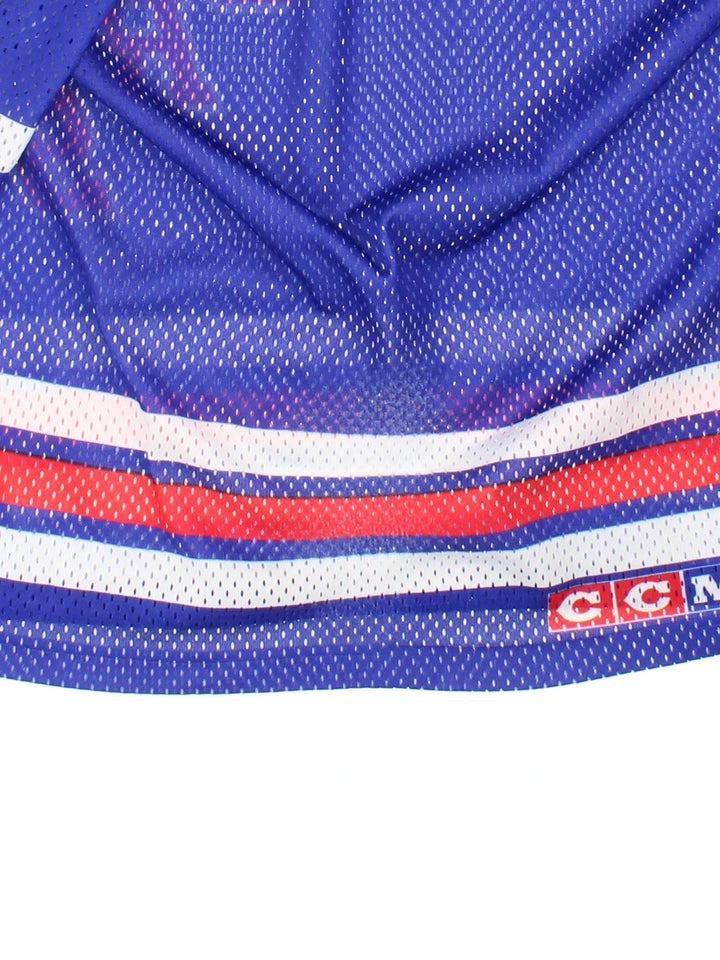 New York Rangers NHL Jersey in the blue/red team colourway, features V neckline, printed logos and badge on the front.