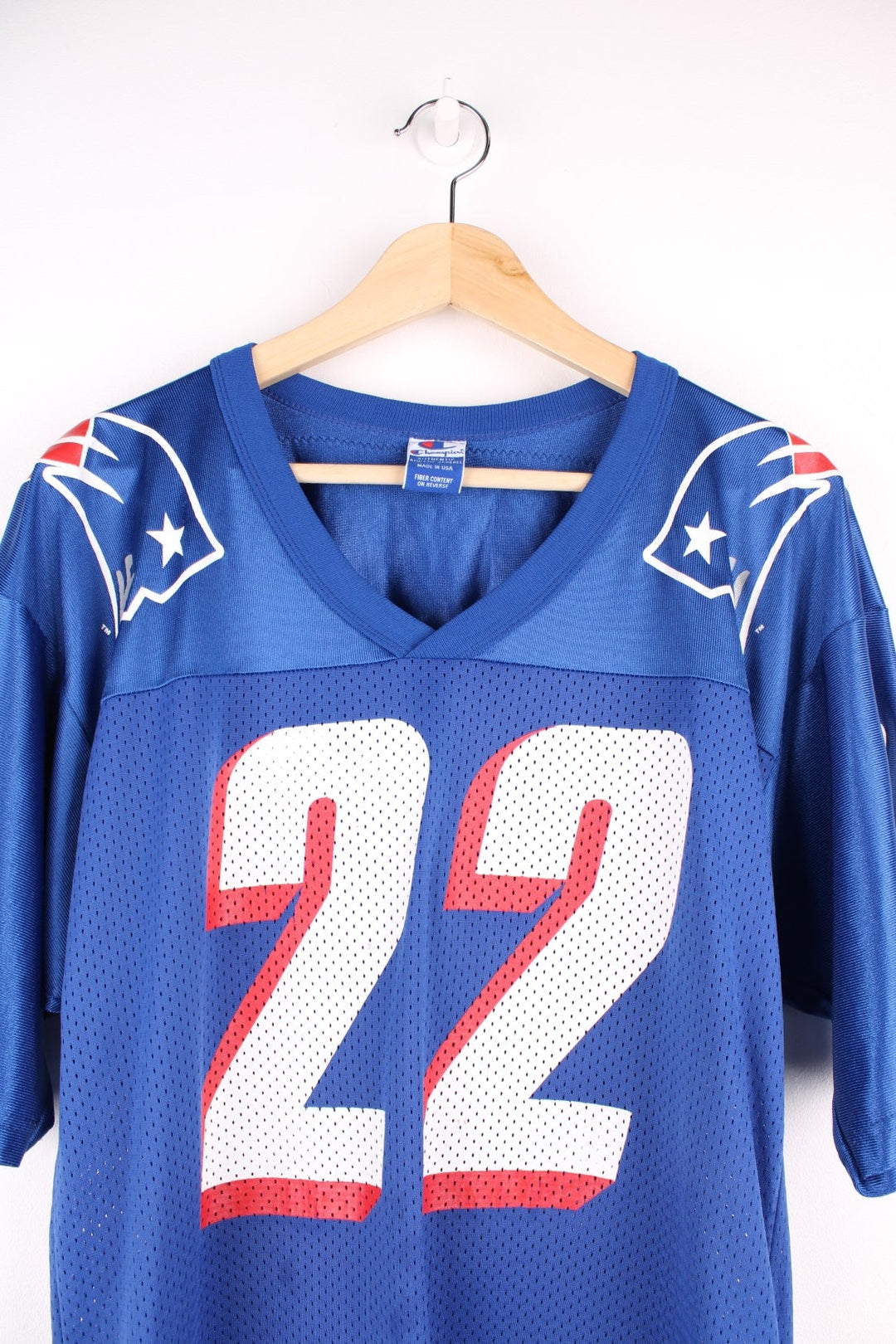 Champion New England Patriots jersey in blue with red and white accents, embroidered champion logos, printed team logos, and no. 22 Meggett on the back.