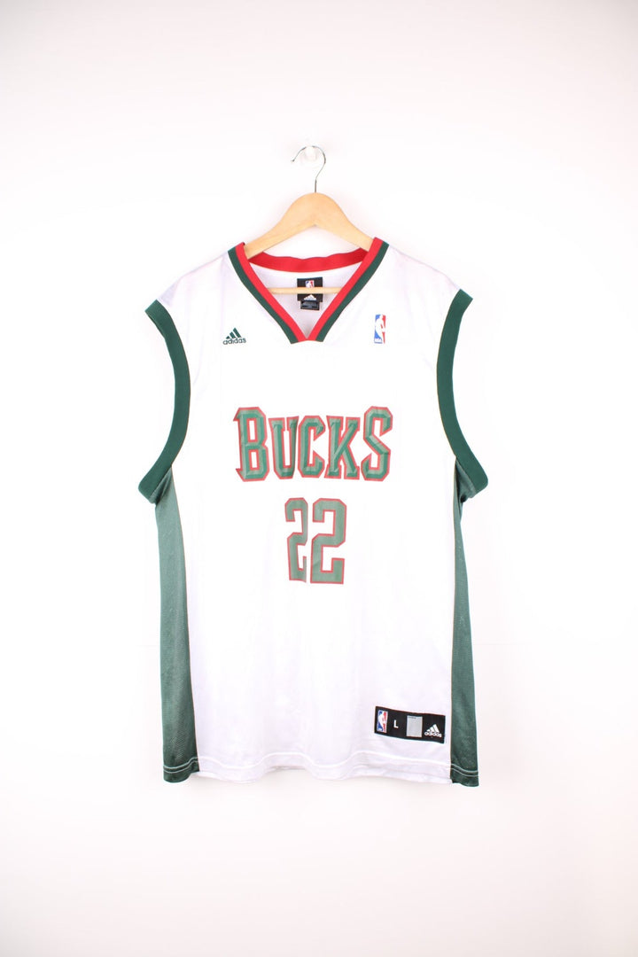 Milwaukee Bucks, Redd #22 Adidas NBA jersey in a white, green and red colourway. Features printed lettering and embroidered logos on the chest.