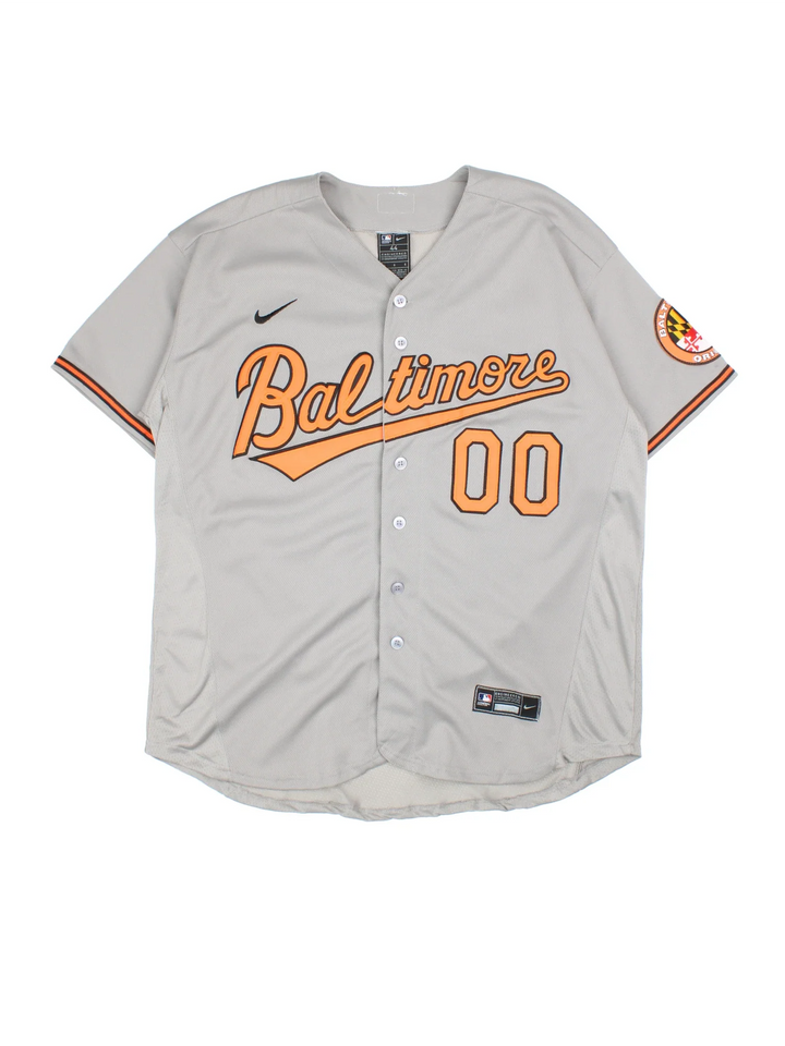Baltimore Orioles Nike MLB Jersey in the grey colourway with orange and black detailing, features embroidered logos and badge on the front and CUSTON #00 on the back.