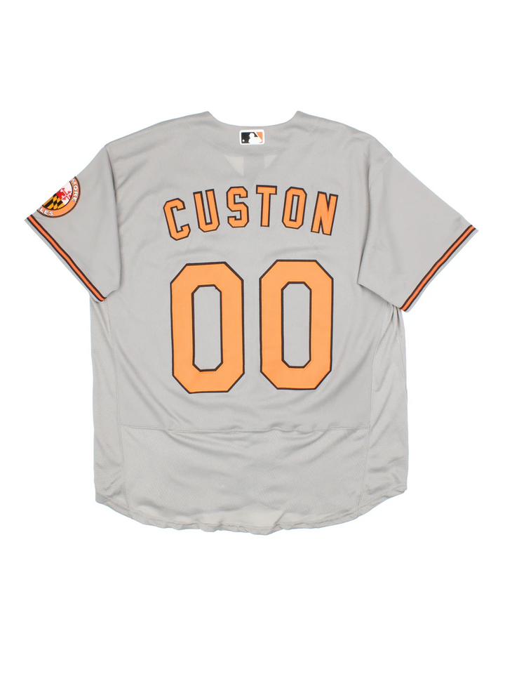 Baltimore Orioles Nike MLB Jersey in the grey colourway with orange and black detailing, features embroidered logos and badge on the front and CUSTON #00 on the back.
