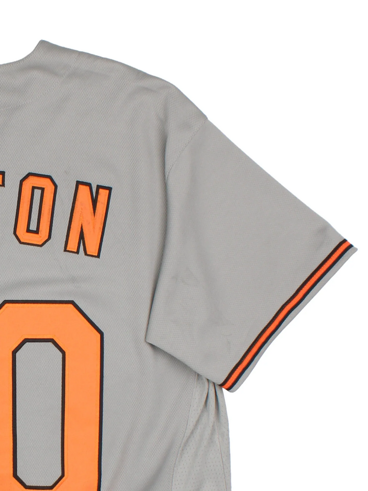 Baltimore Orioles Nike MLB Jersey in the grey colourway with orange and black detailing, features embroidered logos and badge on the front and CUSTON #00 on the back.