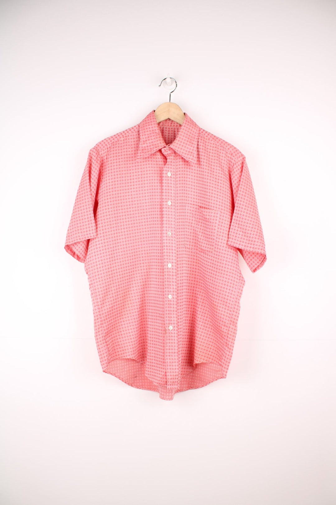 Vintage 70s pink and red patterned shirt with a dagger collar and pocket on the chest.