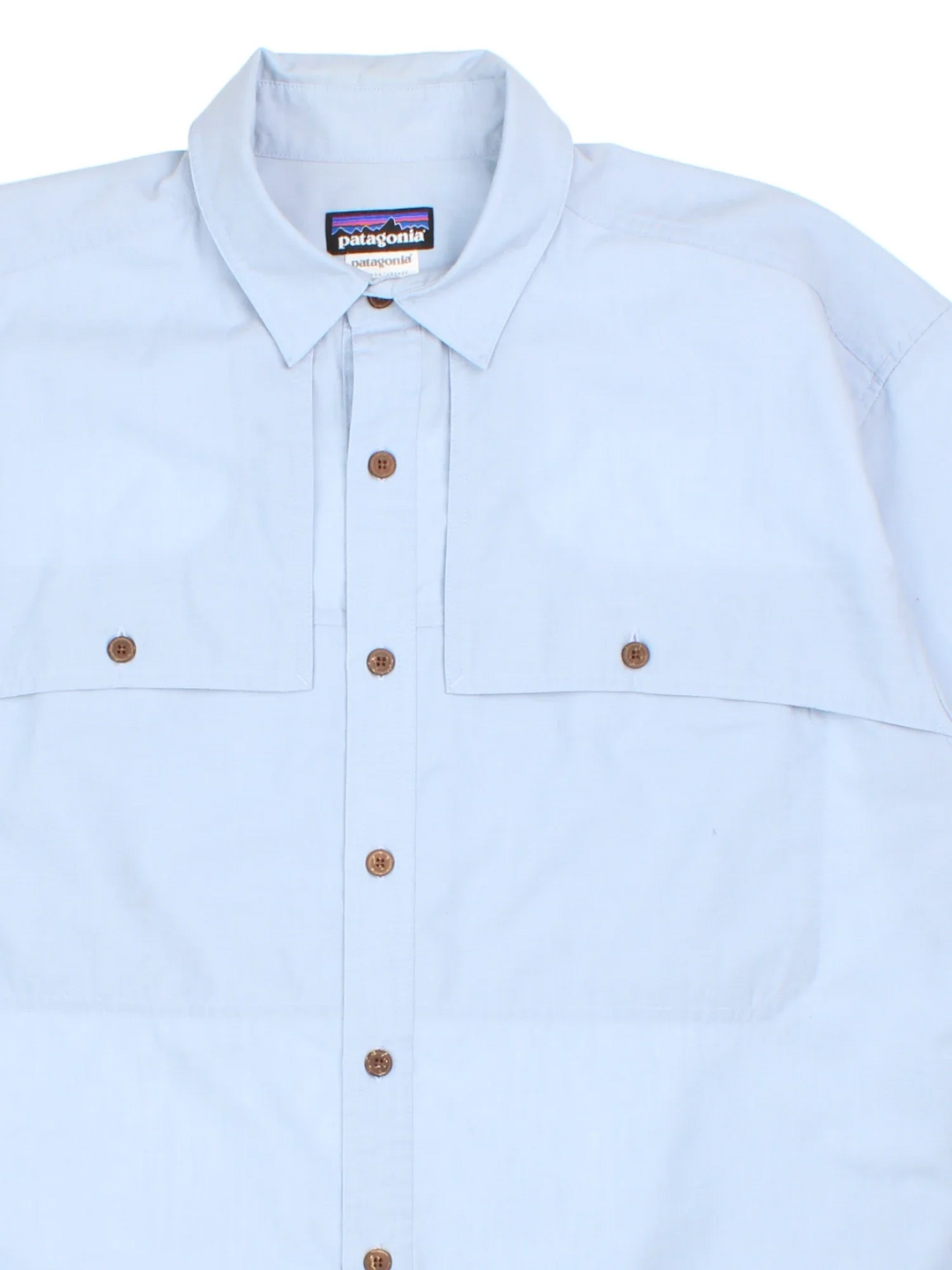 Patagonia Shirt in a blue colourway. Button up, front pocket detail and side tab branding.