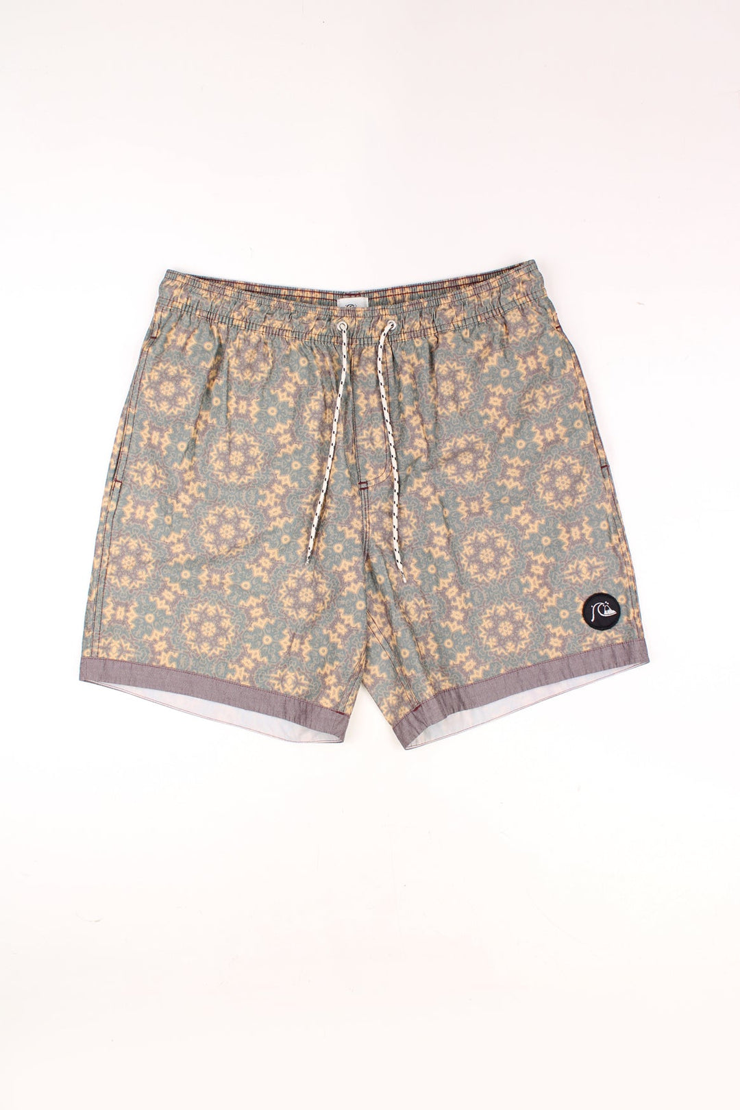 Vintage Quiksilver Shorts in a green, yellow and brown patterned colourway, adjustable waist, and has the logo embroidered on the front and back.