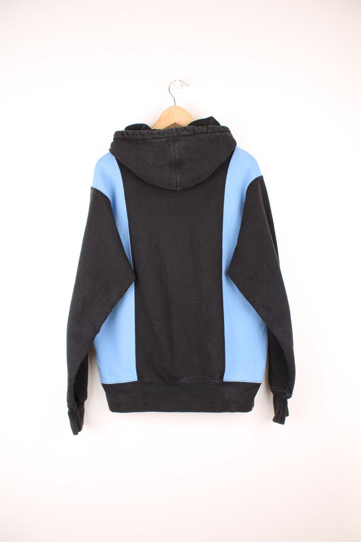 Supreme paneled Arc hoodie in a blue and black colourway with spell out logo across the chest.