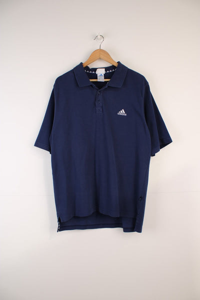 Adidas Polo Shirt in a blue colourway, button up and has the logo embroidered on the front. 