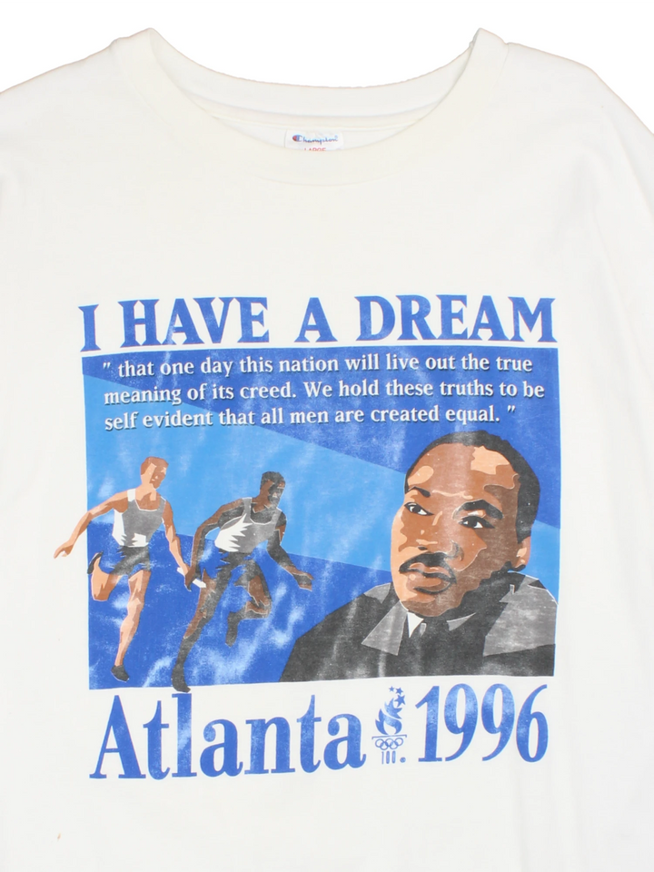 Champion 1996 Atlanta Olympics Martin Luther King Jr T-Shirt in a white colourway with the 'I Have a Dream' quote printed on the front alongside a graphic print of runners and Martin Luther King Jr.