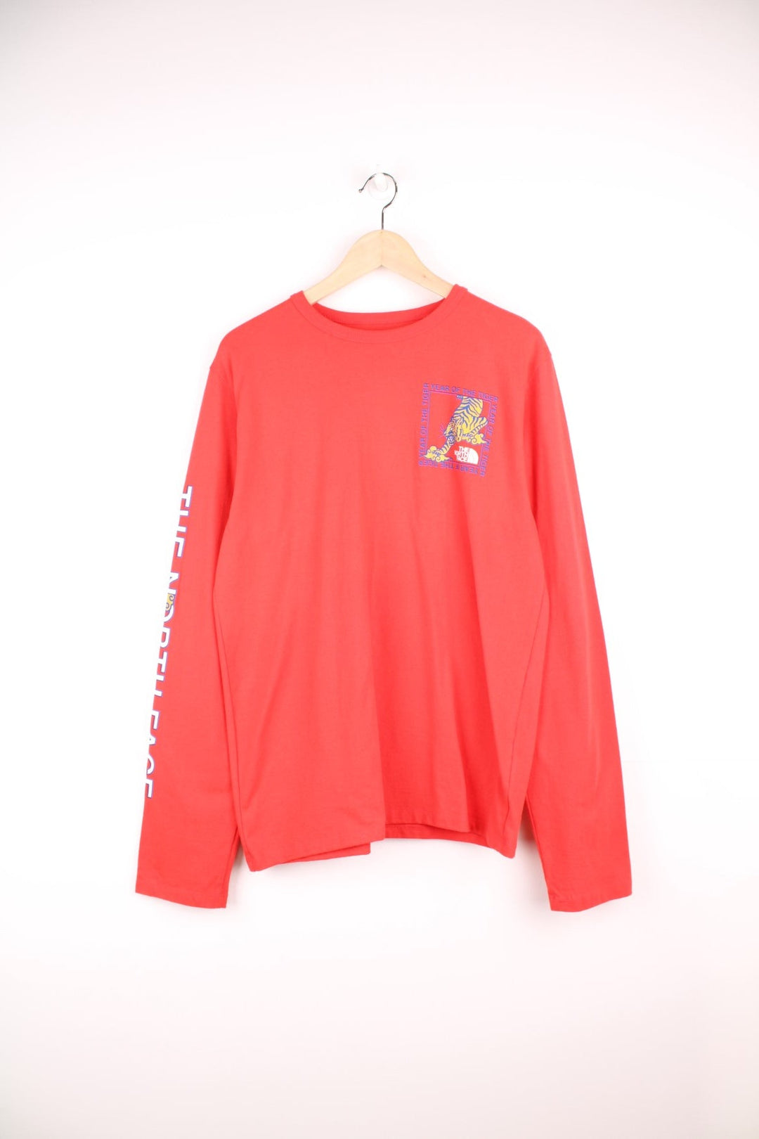 Red North Face long-sleeved t-shirt with 'Year of the Tiger' design on the top left.