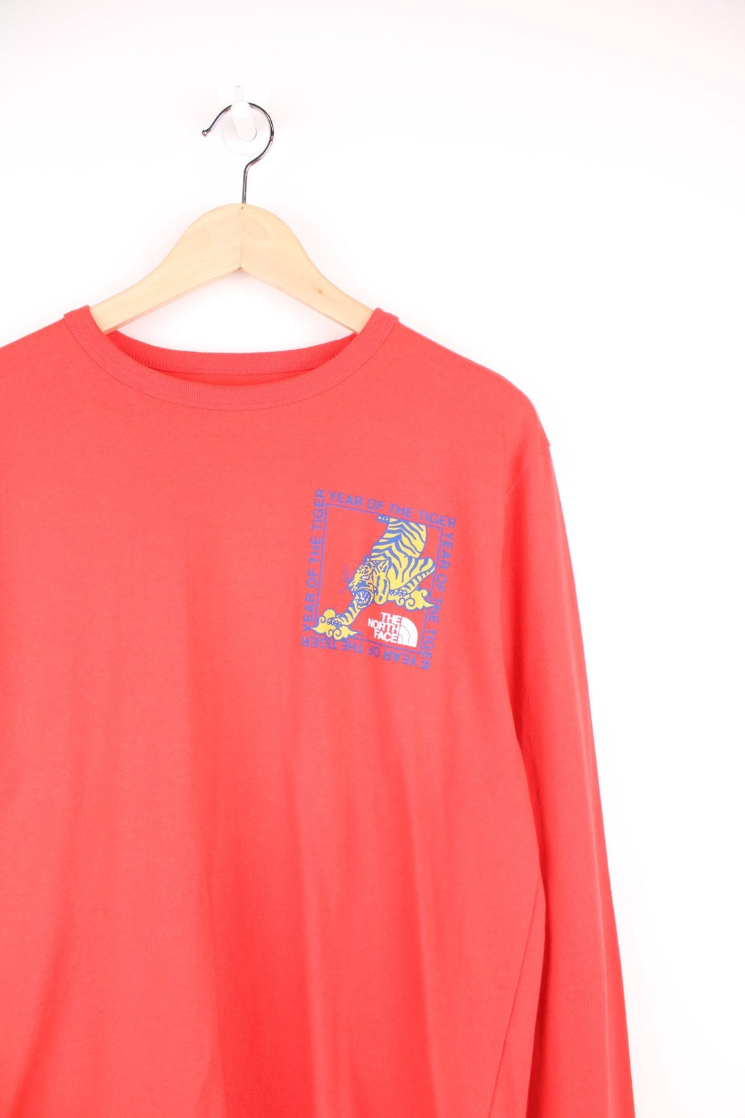 Red North Face long-sleeved t-shirt with 'Year of the Tiger' design on the top left.
