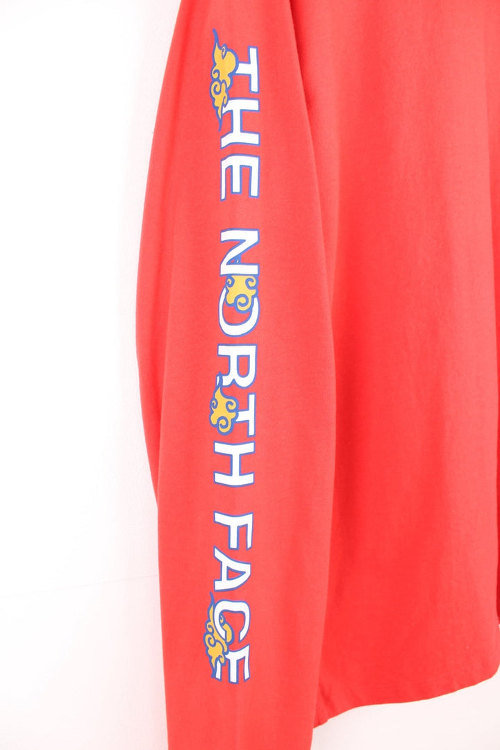 Red North Face long-sleeved t-shirt with 'Year of the Tiger' design on the top left.