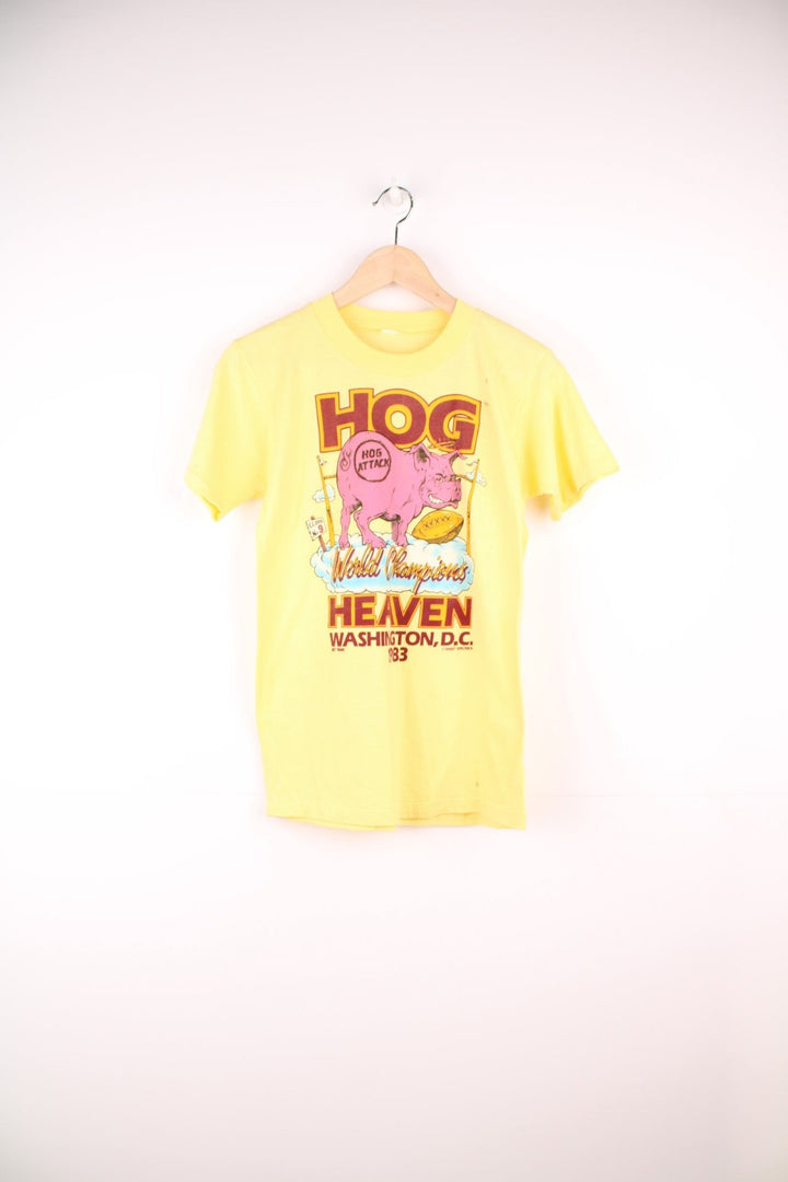 1983 Washington Redskins 'Hog Heaven' World Championships tee in yellow with pig and clouds design.