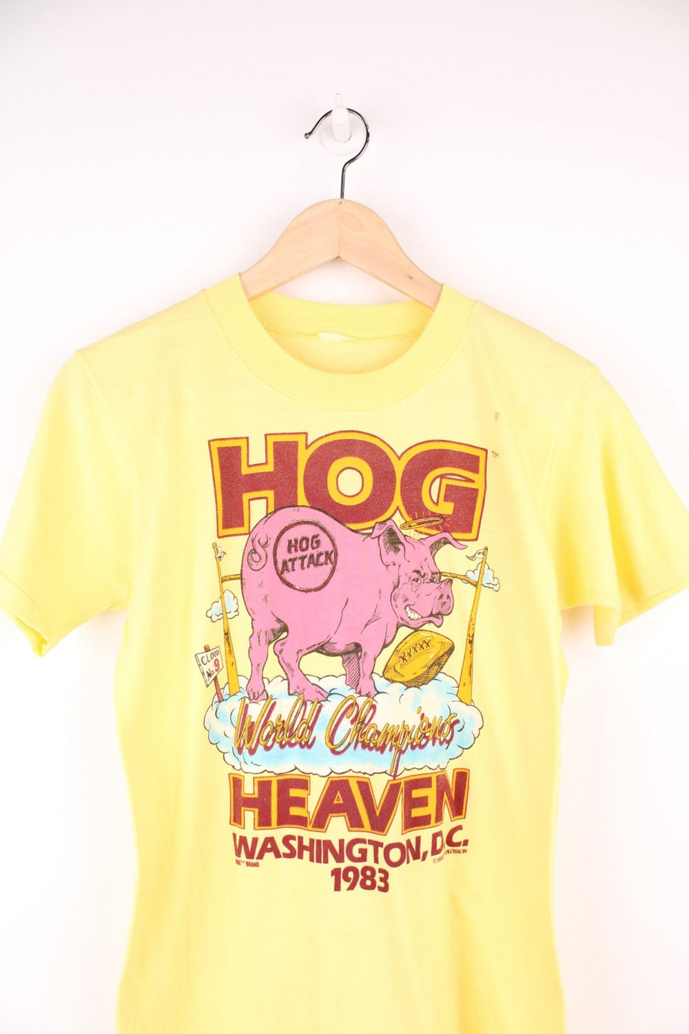 1983 Washington Redskins 'Hog Heaven' World Championships tee in yellow with pig and clouds design.