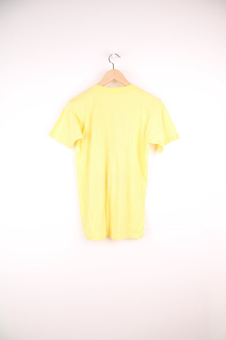 1983 Washington Redskins 'Hog Heaven' World Championships tee in yellow with pig and clouds design.