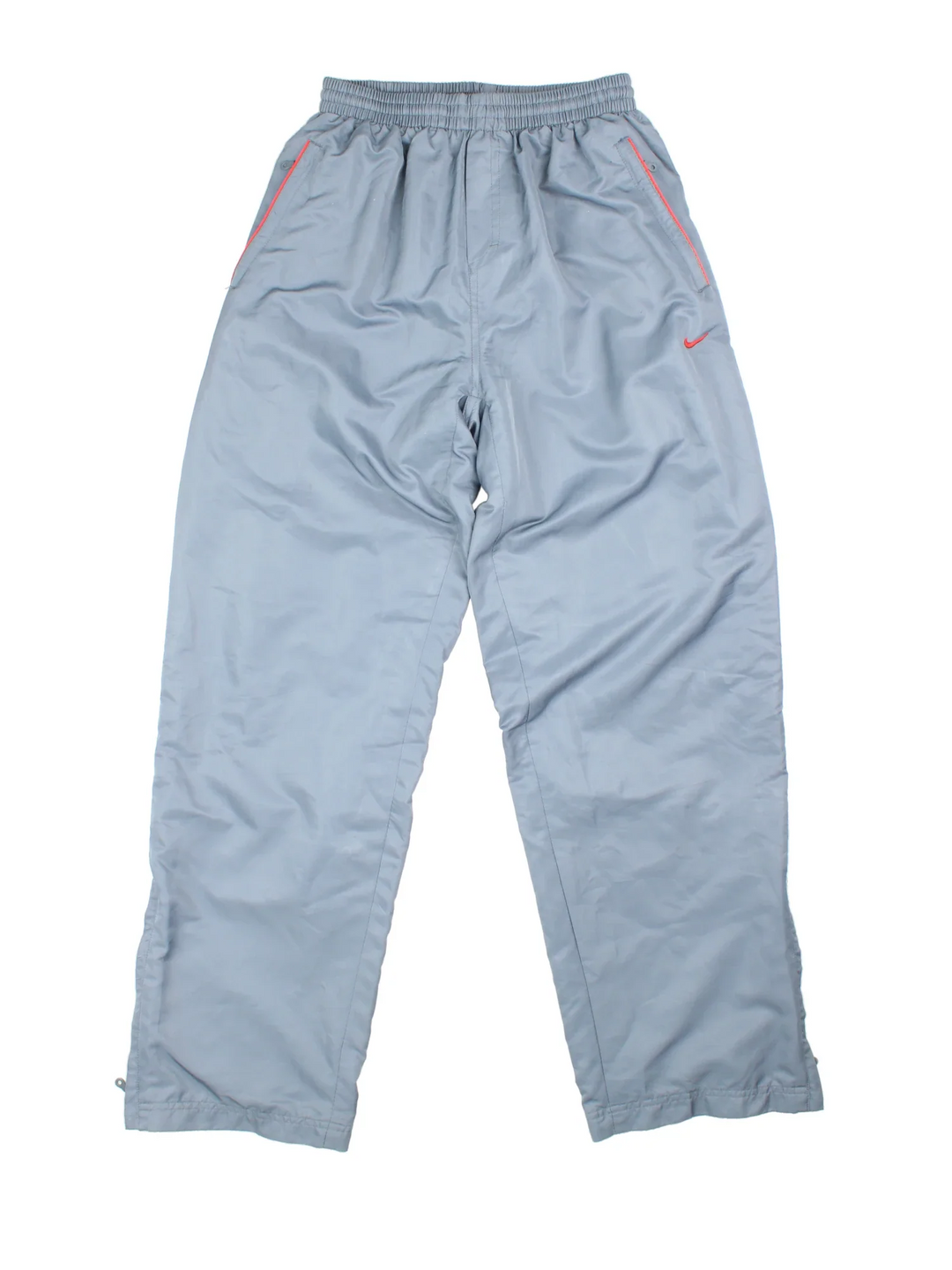 90's Nike Tracksuit Bottoms in grey colourway. Side pockets, elasticated waist, contrast piping and the logo embroidered on the front.