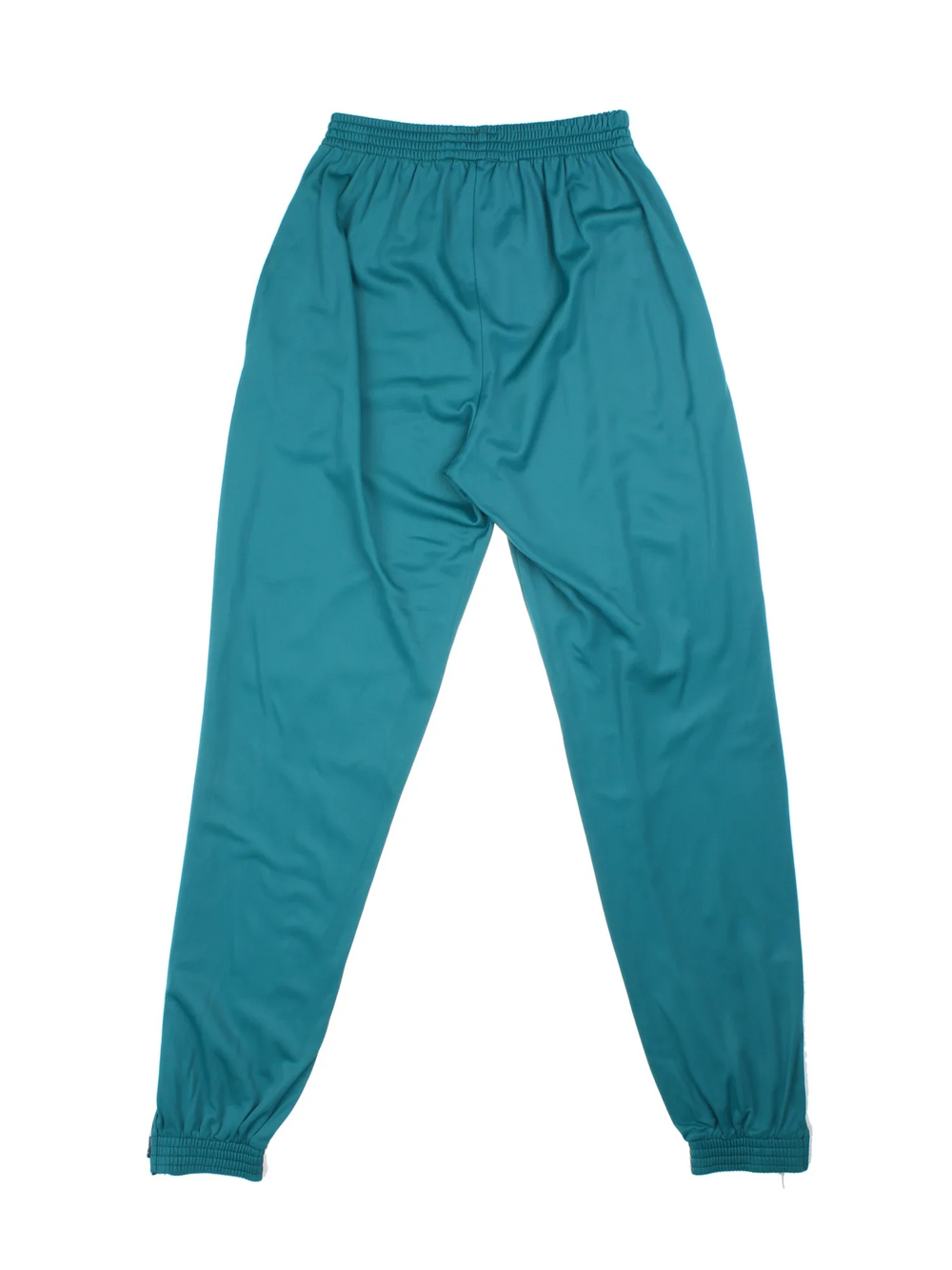 Puma Tracksuit Bottoms in a turqouise green colourway with pockets, elasticated waist, and the logo embroidered on the front.