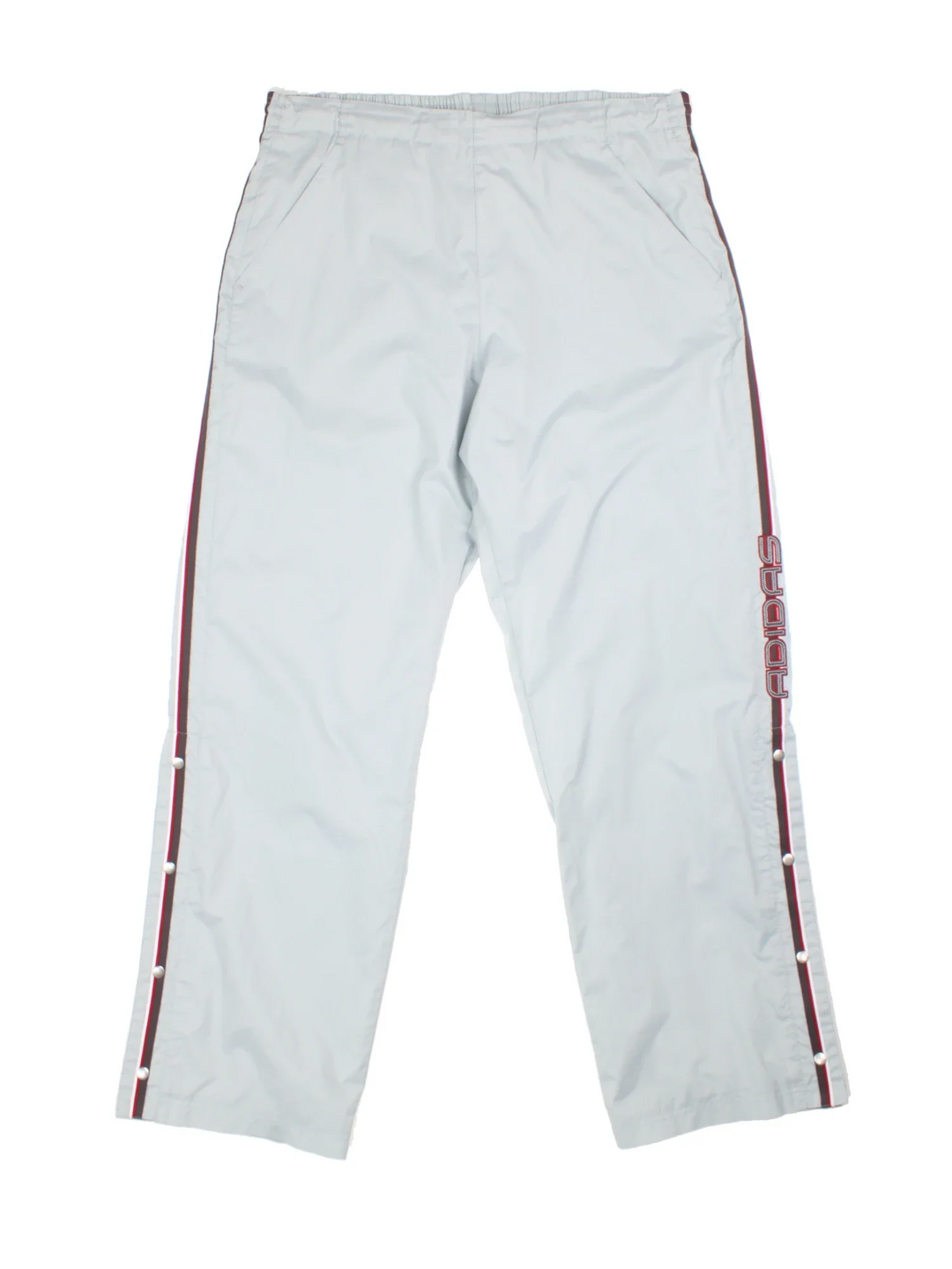 Y2K Adidas Popper Tracksuit Bottoms in a light blue colourway, has pockets, elasticated waist with drawstring, and the logo embroidered down left leg alongside the popper buttons on either side.