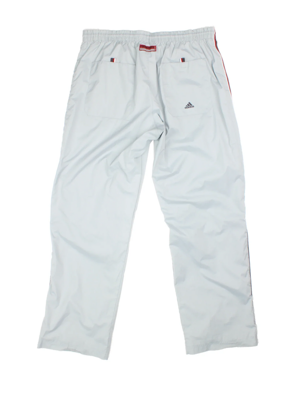 Y2K Adidas Popper Tracksuit Bottoms in a light blue colourway, has pockets, elasticated waist with drawstring, and the logo embroidered down left leg alongside the popper buttons on either side.