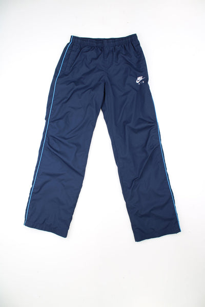 Nike Air straight leg tracksuit bottoms with elasticated drawstring waist, embroidered logo and stripe detail on each leg.