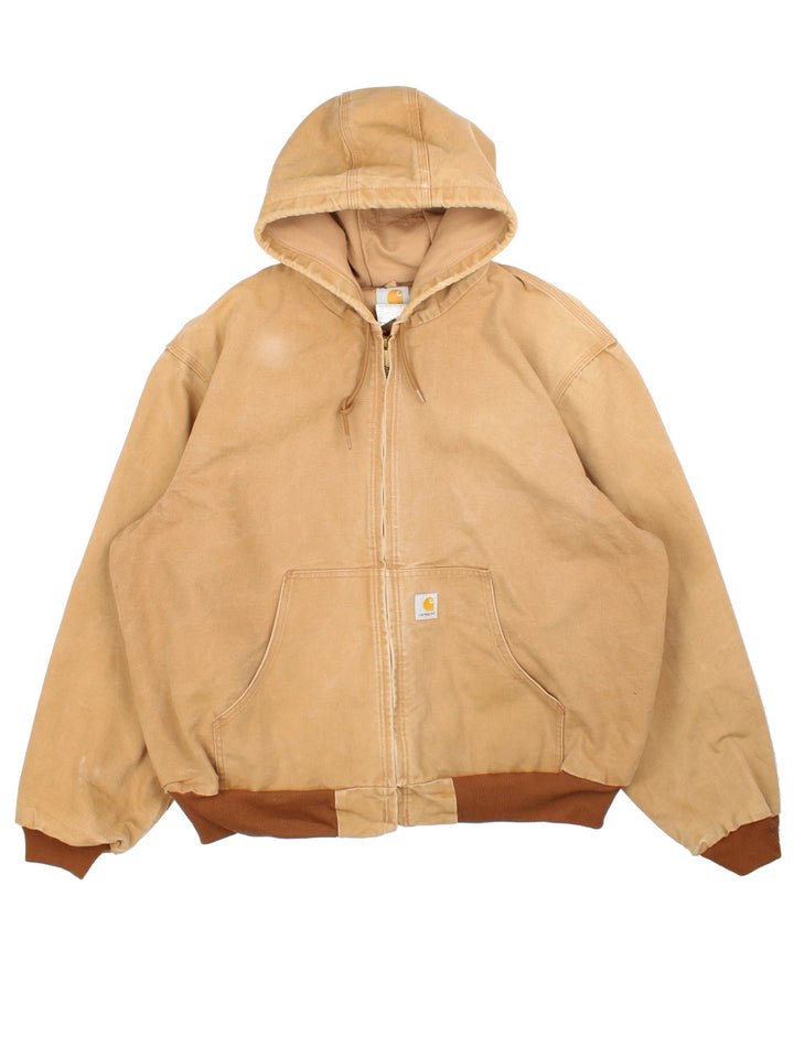 Vintage Carhartt Active Jacket in a tan colourway. Zip up closure and has side pockets, insulated lining, and has the logo embroidered on the front.