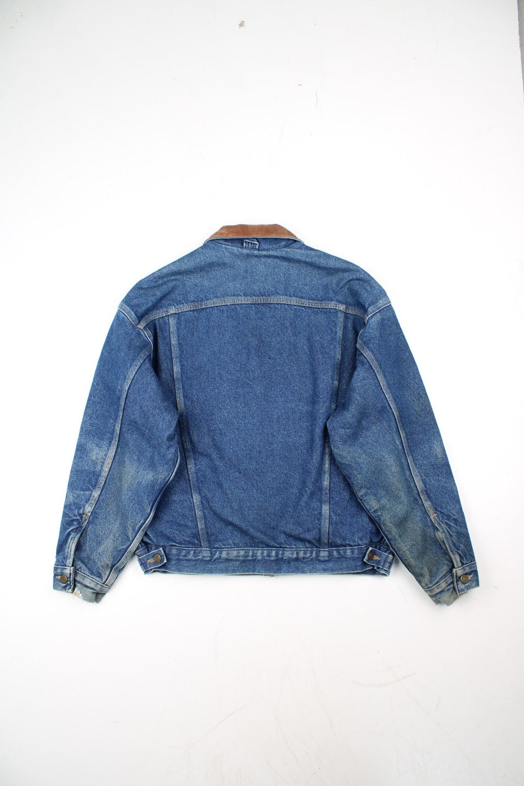 Vintage Carhartt Denim Jacket in a blue colourway with a brown corduroy collar. Buttons up and has multiple pockets, insulated with a blanket lining, and has the logo embroidered on the front.