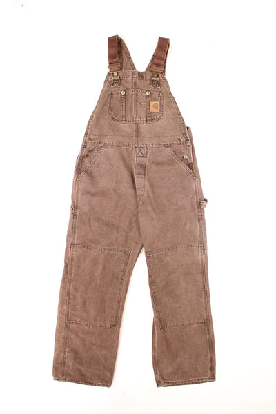 Carhartt Dungarees in a brown colourway, multiple pockets, quilted lining, and has the logo embroidered on the front. 
