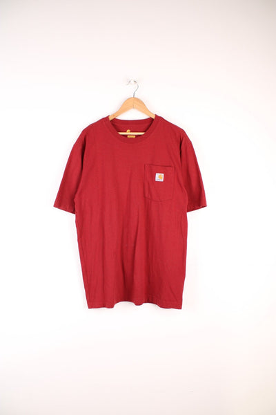 Carhartt T-Shirt in a plain red colourway, has a chest pocket and logo embroidered on it. 