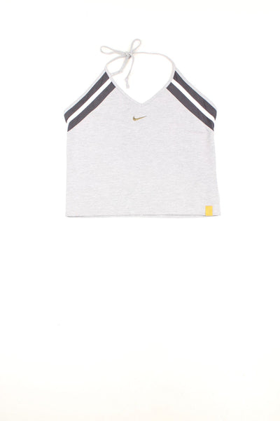 Nike grey tie-neck halter top with dark grey and white stripe detailing, Nike swoosh embroidered in gold, and a yellow spellout 'just do it' tag on the bottom left.
