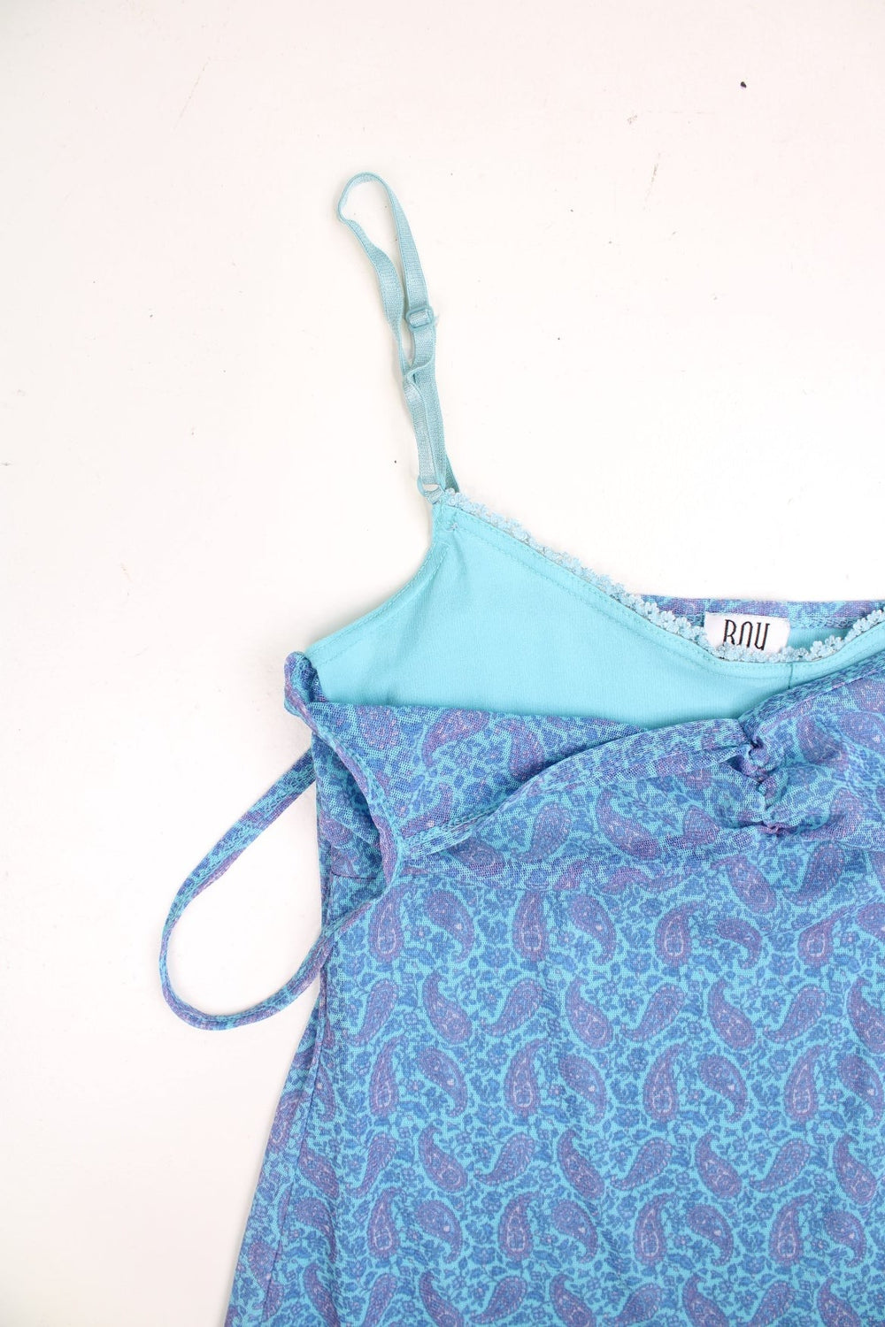 Y2K BAY blue and purple midi dress with a floral and paisley pattern, adjustable straps, a lettuce hem, and a ruched bust.