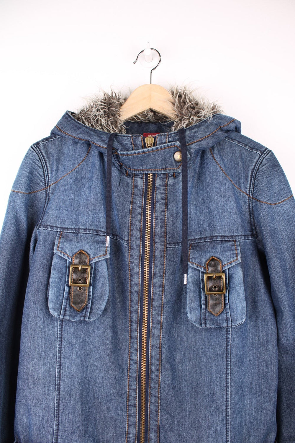 Blue Miss Sixty denim parka with faux fur lined hood, zip closure, eight zip, snap and buckle pockets.