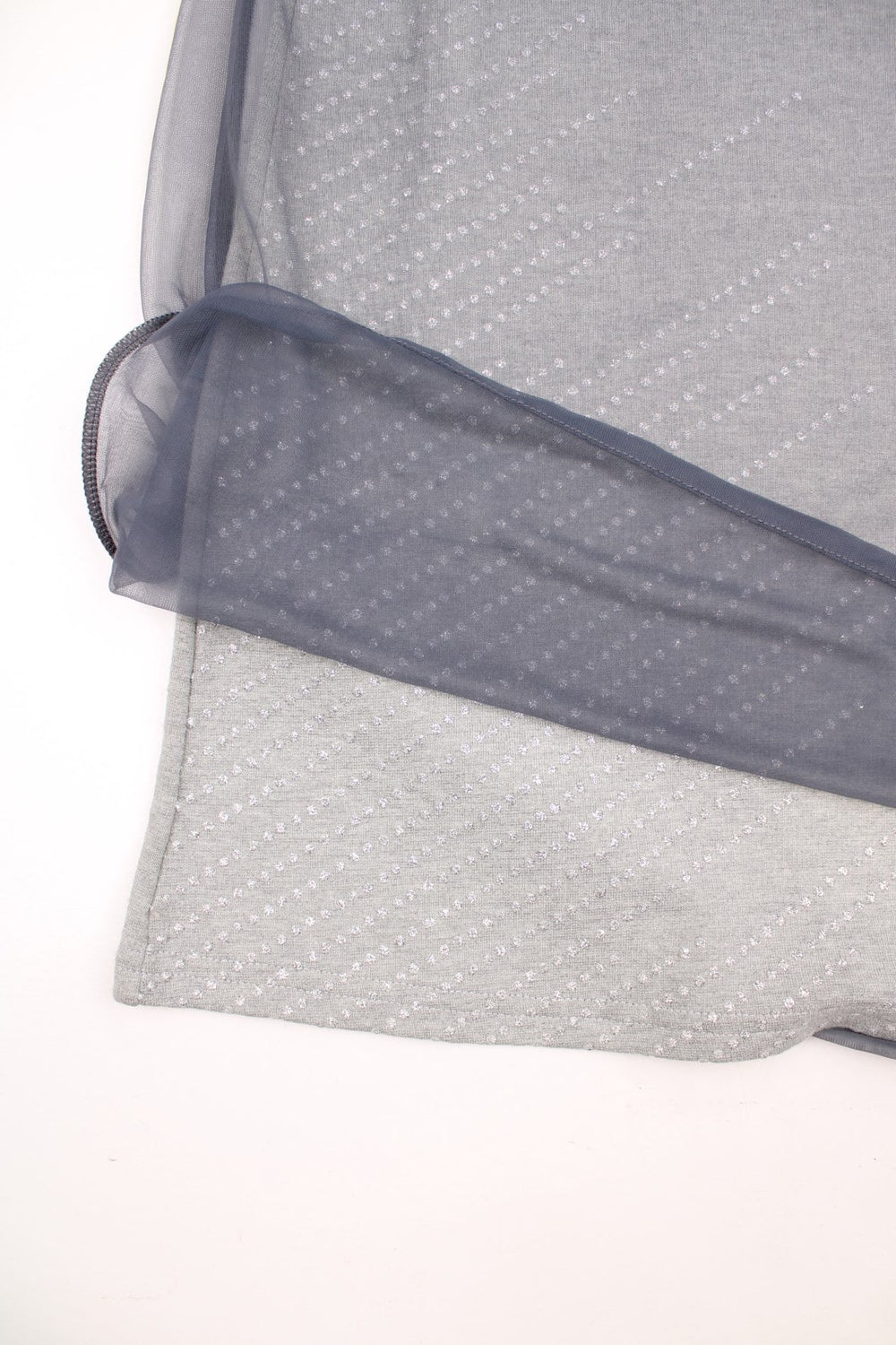 Y2K Morgan de Toi skirt in grey with silver glitter detailing, an elasticated waistband and a darker grey mesh overlayer.