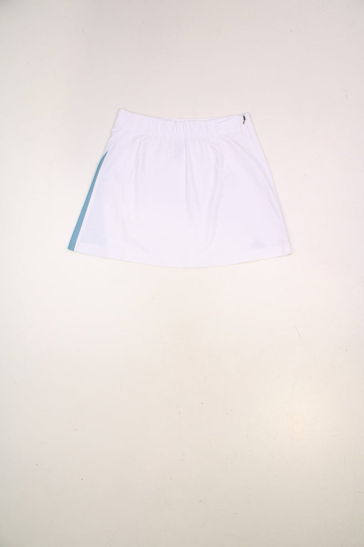 Y2K Adidas mini tennis skirt in white with blue three-stripe design on one side.