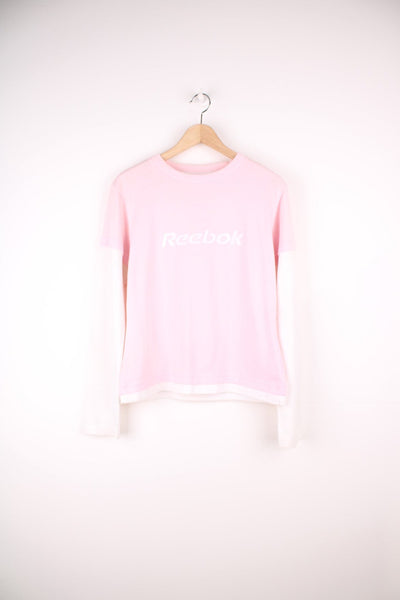 Reebok long sleeved top in pink and white with embroidered spell out logo across the chest. 