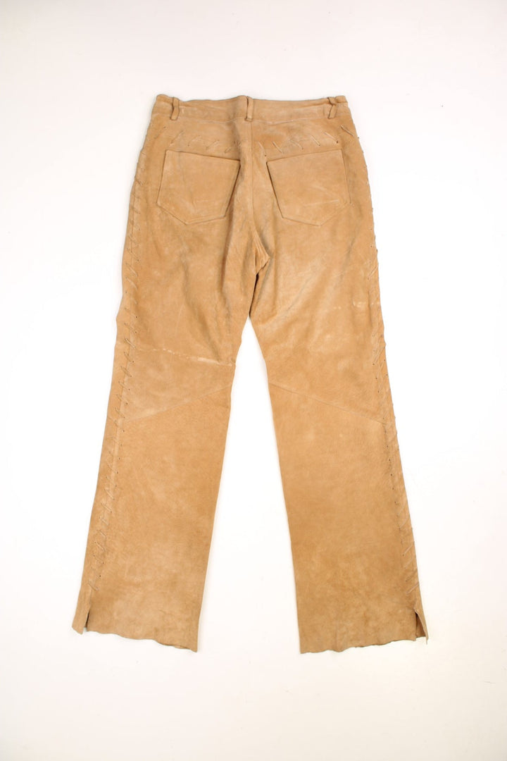 Western Leather Trousers in a  brown colourway with multiple pockets, and has cross stitching tassels down the side of the legs and round the back.