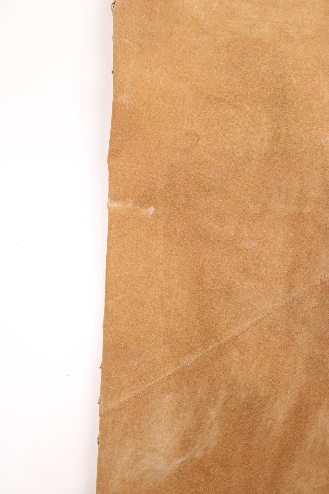 Western Leather Trousers in a  brown colourway with multiple pockets, and has cross stitching tassels down the side of the legs and round the back.