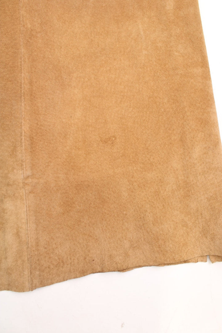 Western Leather Trousers in a  brown colourway with multiple pockets, and has cross stitching tassels down the side of the legs and round the back.