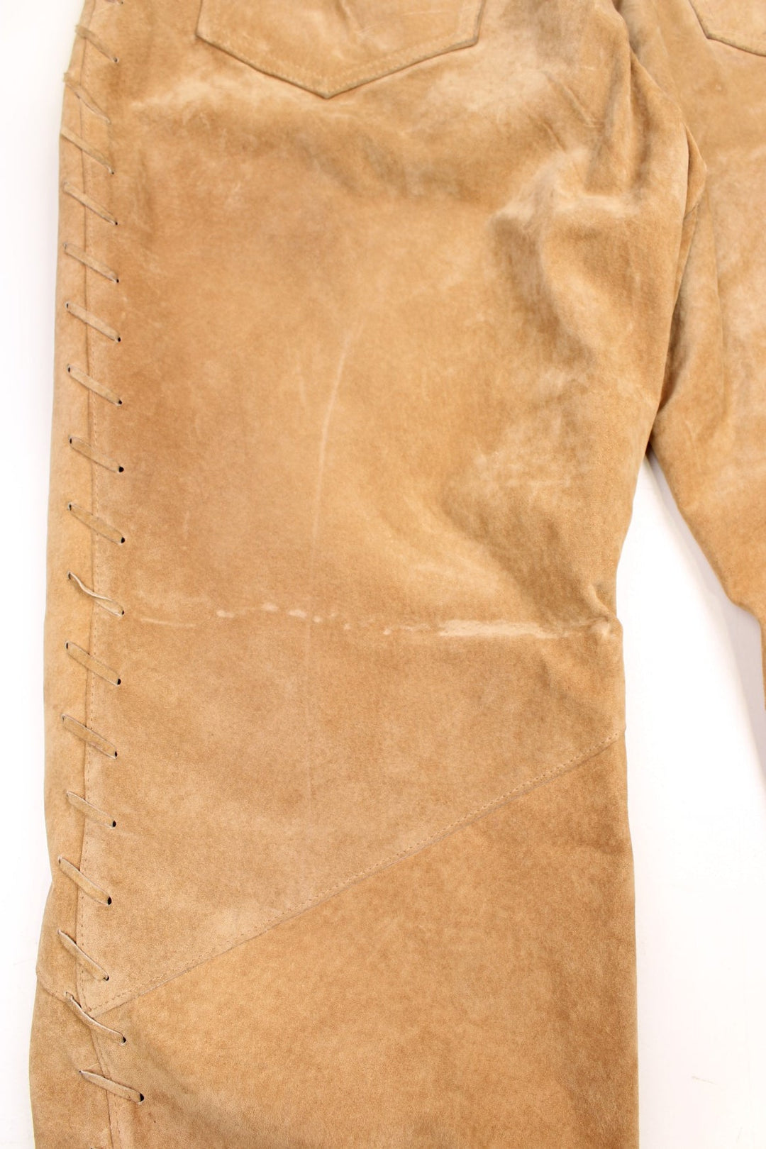 Western Leather Trousers in a  brown colourway with multiple pockets, and has cross stitching tassels down the side of the legs and round the back.