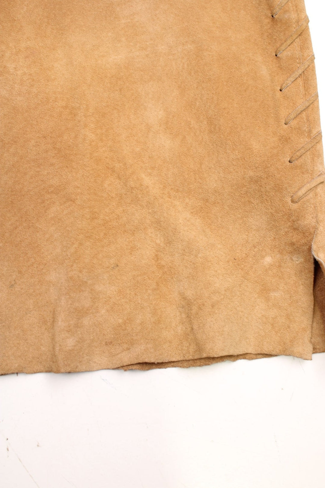 Western Leather Trousers in a  brown colourway with multiple pockets, and has cross stitching tassels down the side of the legs and round the back.