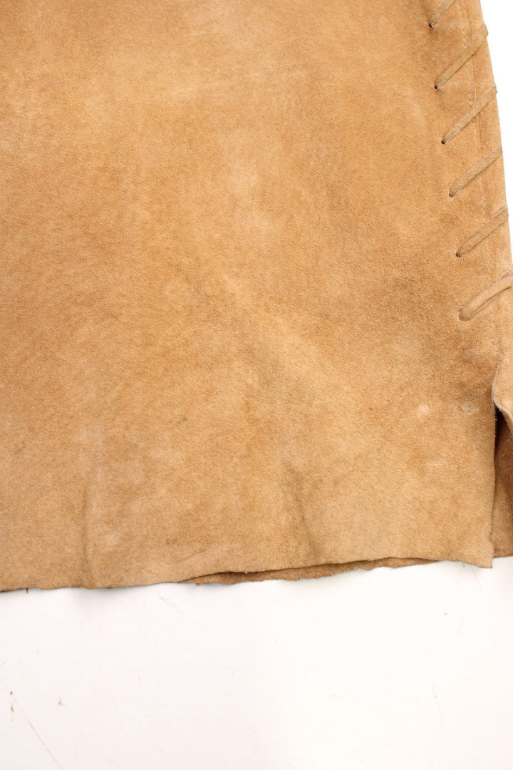 Western Leather Trousers in a  brown colourway with multiple pockets, and has cross stitching tassels down the side of the legs and round the back.