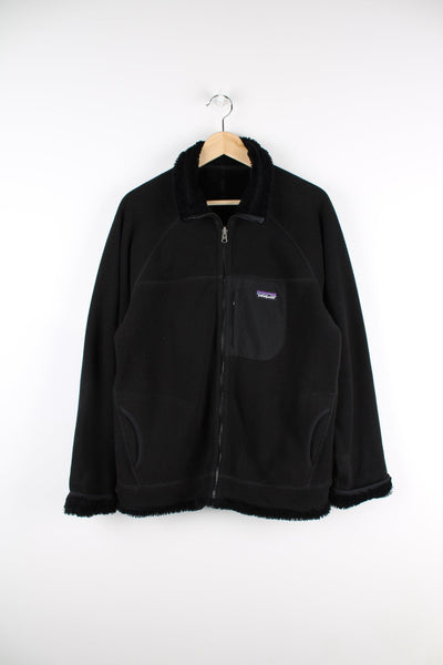 Black Patagonia reversible fleece jacket featuring chest pocket and embroidered logo.