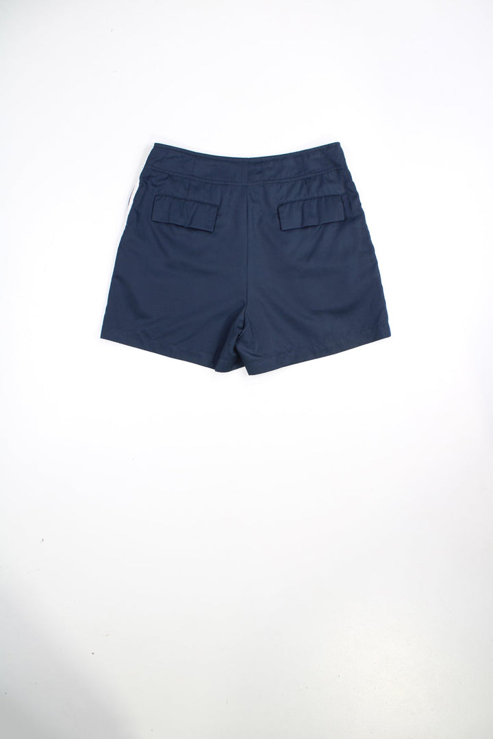 Vintage Ellesse shorts with drawstring waist and popper fastenings. Features stripe detailing and printed logo.