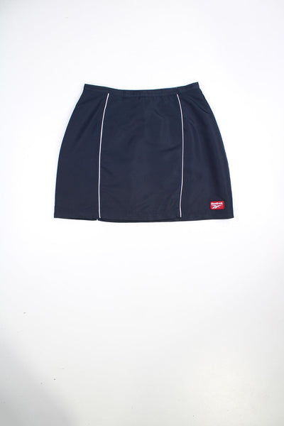 Vintage Reebok wrap skirt with velcro fastening. Features white piping detail and embroidered logo.