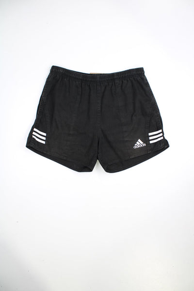 Black Adidas vintage shorts with elasticated waist and drawstring. Features signature three stripes and embroidered logo.