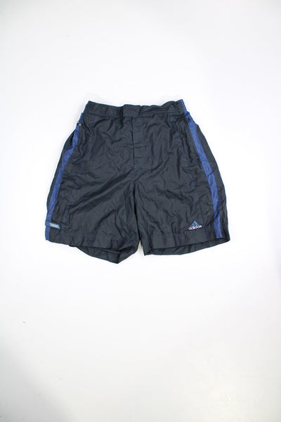 Vintage 90s Adidas shorts with velcro fastening. Features embroidered logo and blue stripe detail.