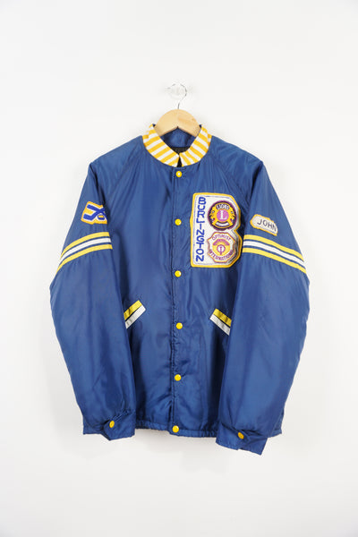 Vintage 1970s/80s blue bomber jacket with embroidered Burlington badges and quilted lining