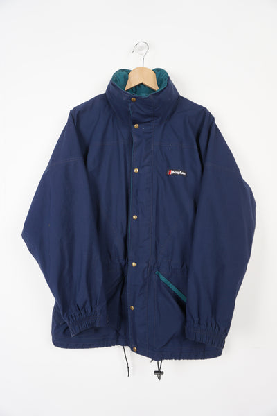 Blue Berghaus Gore-tex Cornice I.A zip through jacket with hood and embroidered logo on the chest and foldaway hood