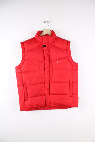 Red Nike zip through puffer gilet. Features embroidered logo on the chest.